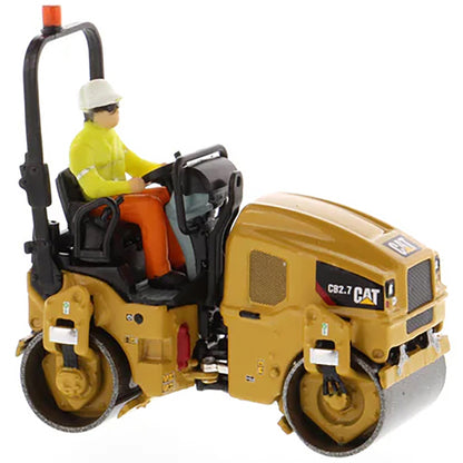 Model of a Caterpillar CB-2.7 Tandem Vibratory Road Roller with Operator on a White Background 