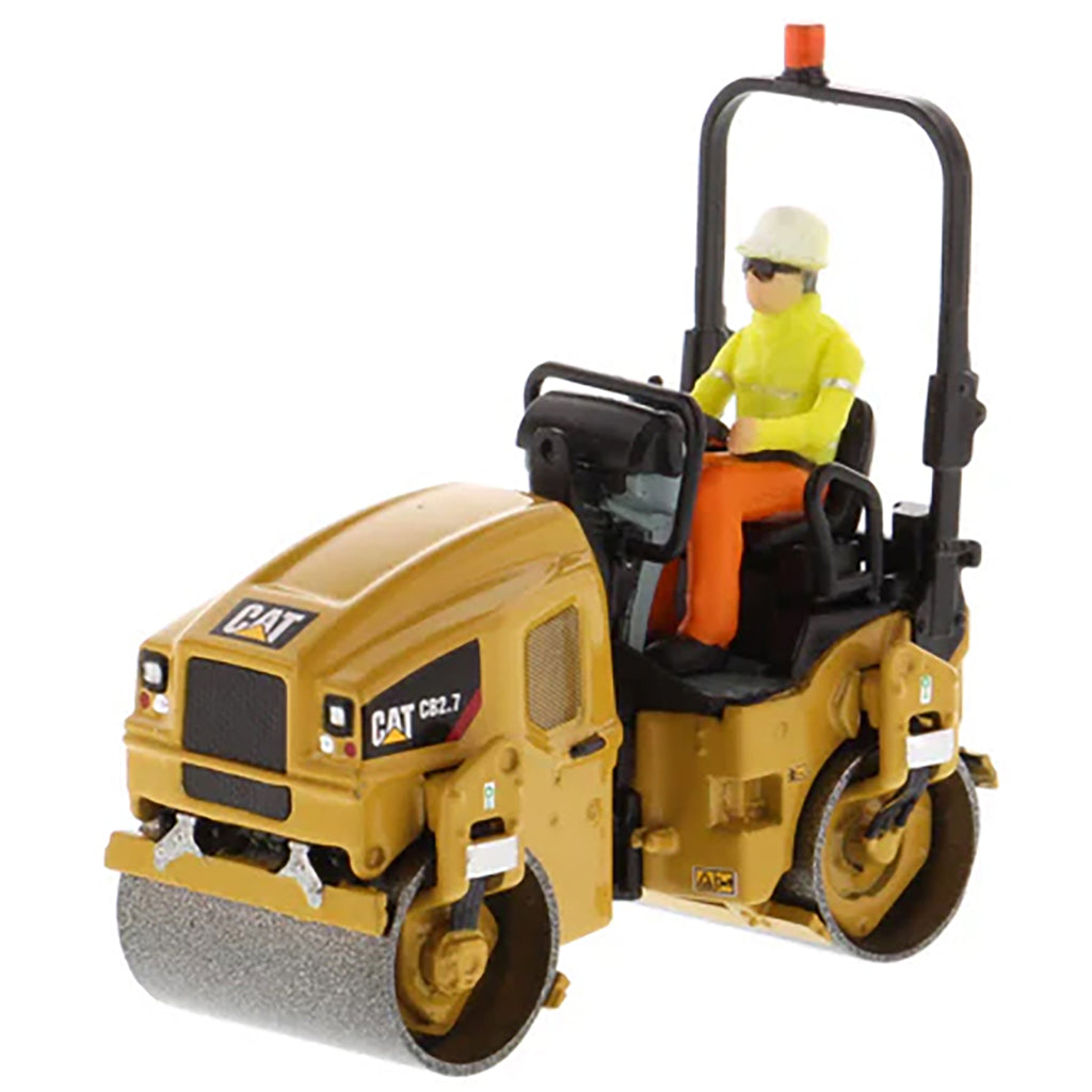 Model of a Caterpillar CB-2.7 Tandem Vibratory Road Roller with Operator on a White Background 