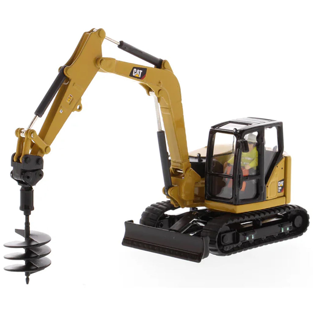 Model of a Caterpillar 308 CR Mini Hydraulic Excavator with Operator on a White Background