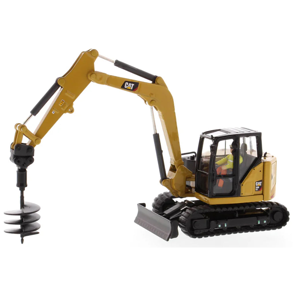 Model of a Caterpillar 308 CR Mini Hydraulic Excavator with Operator on a White Background