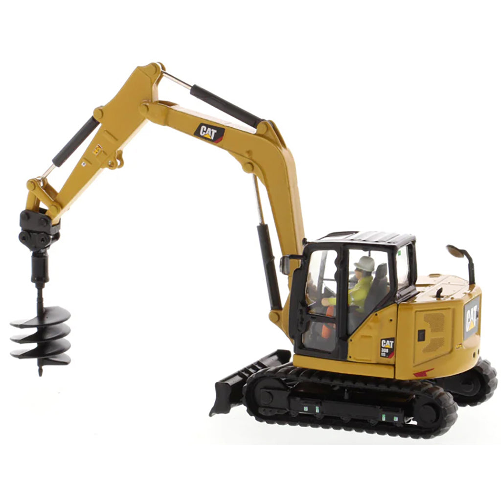 Model of a Caterpillar 308 CR Mini Hydraulic Excavator with Operator on a White Background