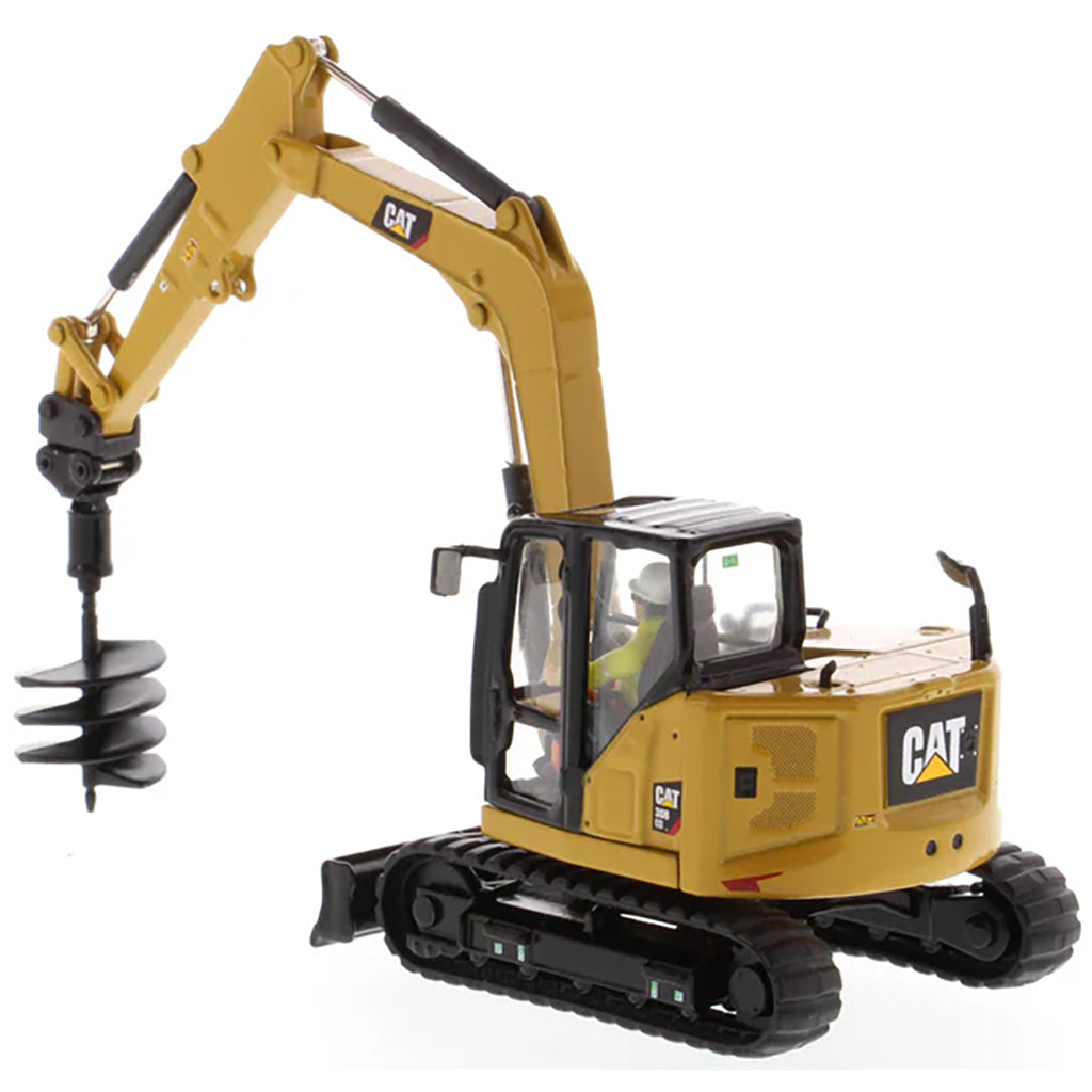 Model of a Caterpillar 308 CR Mini Hydraulic Excavator with Operator on a White Background