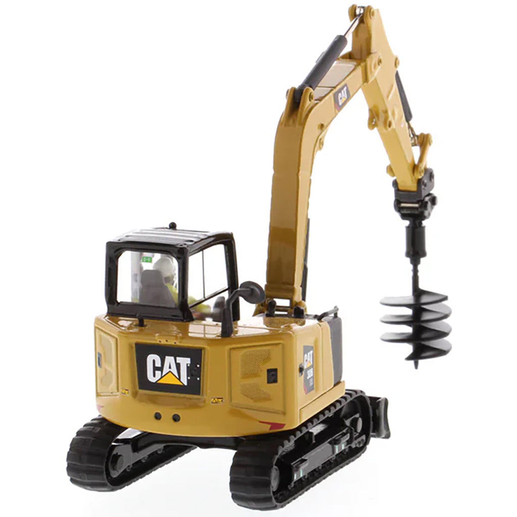 Model of a Caterpillar 308 CR Mini Hydraulic Excavator with Operator on a White Background