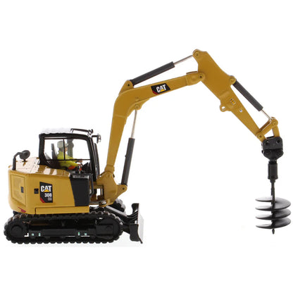 Model of a Caterpillar 308 CR Mini Hydraulic Excavator with Operator on a White Background