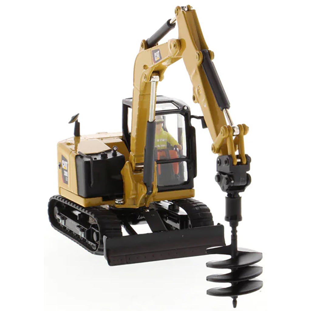 Model of a Caterpillar 308 CR Mini Hydraulic Excavator with Operator on a White Background