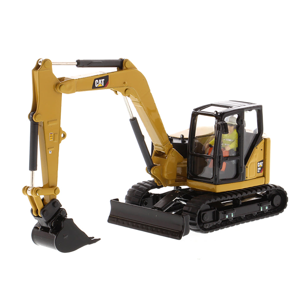 Model of a Caterpillar 308 CR Mini Hydraulic Excavator with Operator on a White Background