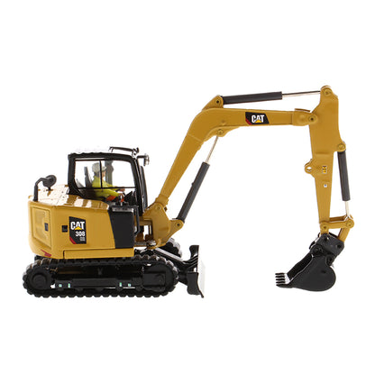 Model of a Caterpillar 308 CR Mini Hydraulic Excavator with Operator on a White Background