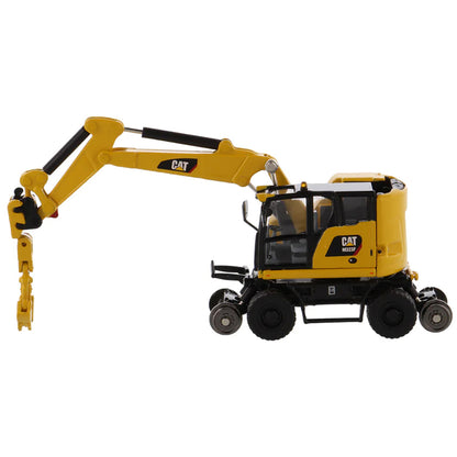 Model of a Safety Yellow Caterpillar M323F Railroad Wheeled Excavator on a White Background