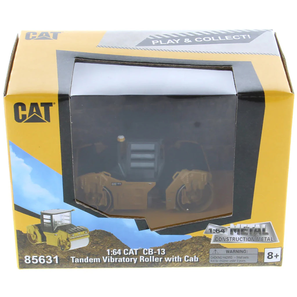Boxed model of a Caterpillar tandem vibratory roller with cab, featuring the Caterpillar logo.
