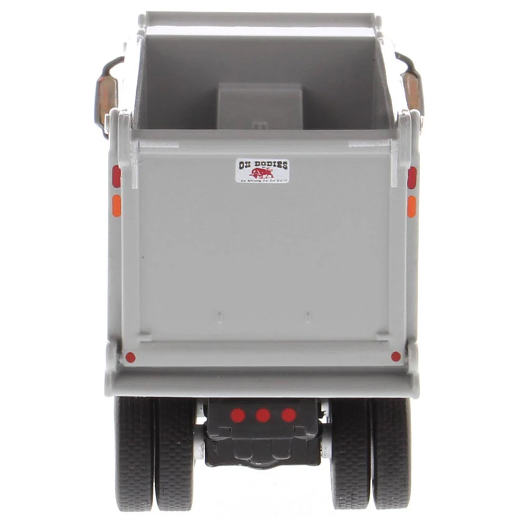Gray dump trailer with visible brand logo on a white background