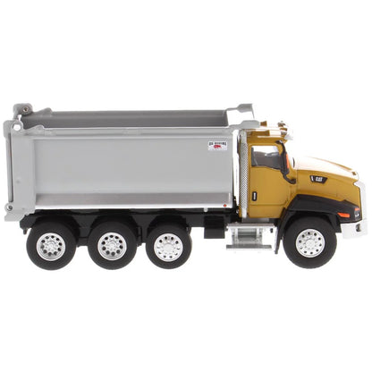 Model of a yellow dump truck with a gray bed on a white background