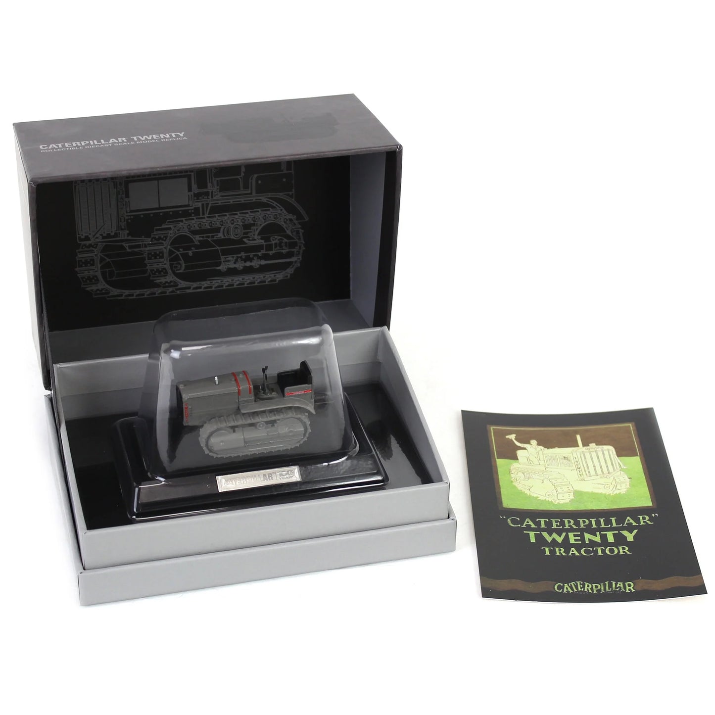 Model tractor in a display box with a leaflet on a white background