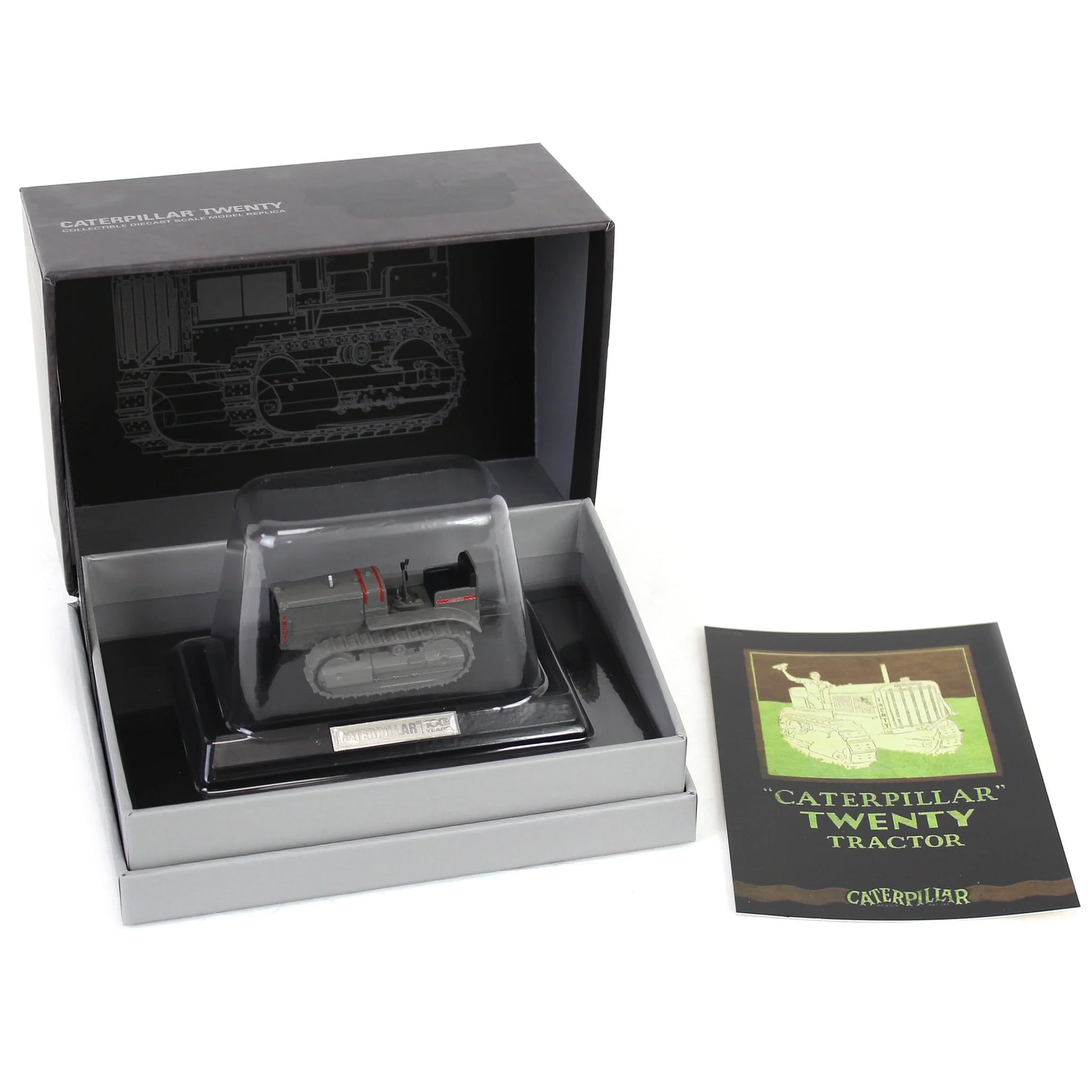 Model tractor in a display box with a leaflet on a white background