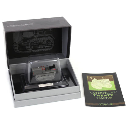 Model tractor in a display box with a leaflet on a white background