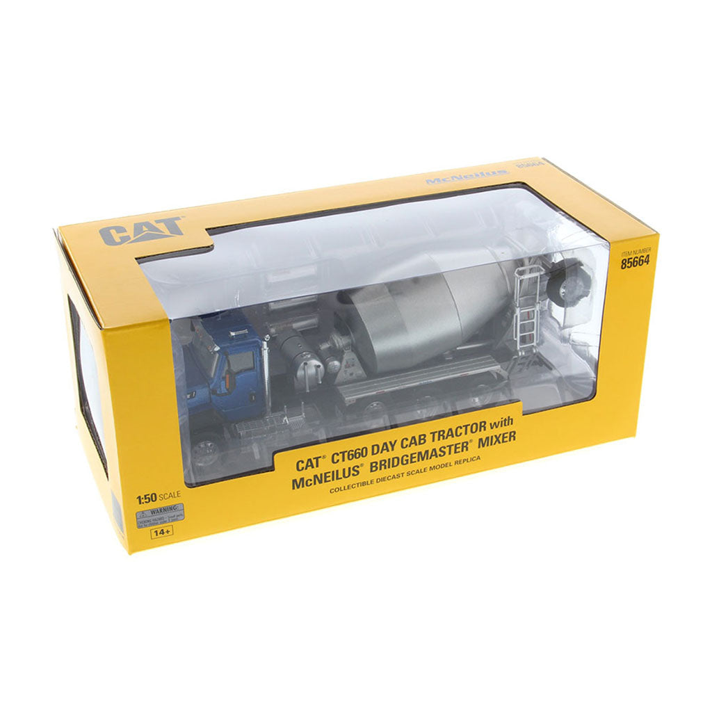 Model of a blue Caterpillar CT660 cement truck with a large silver mixer in retail window box packaging on a white background