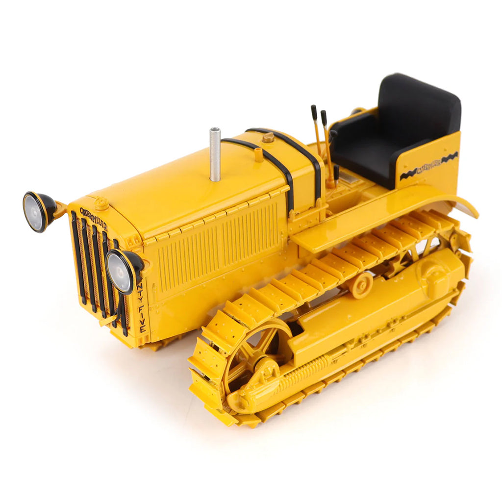 Model of a CAT Machine Yellow Caterpillar Twenty-Five Crawler Tractor with Headlights on a White Background