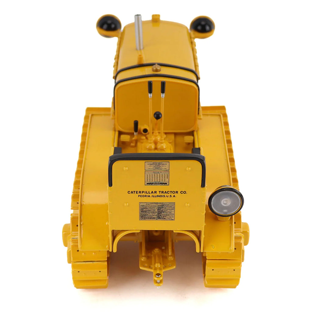 Model of a CAT Machine Yellow Caterpillar Twenty-Five Crawler Tractor with Headlights on a White Background