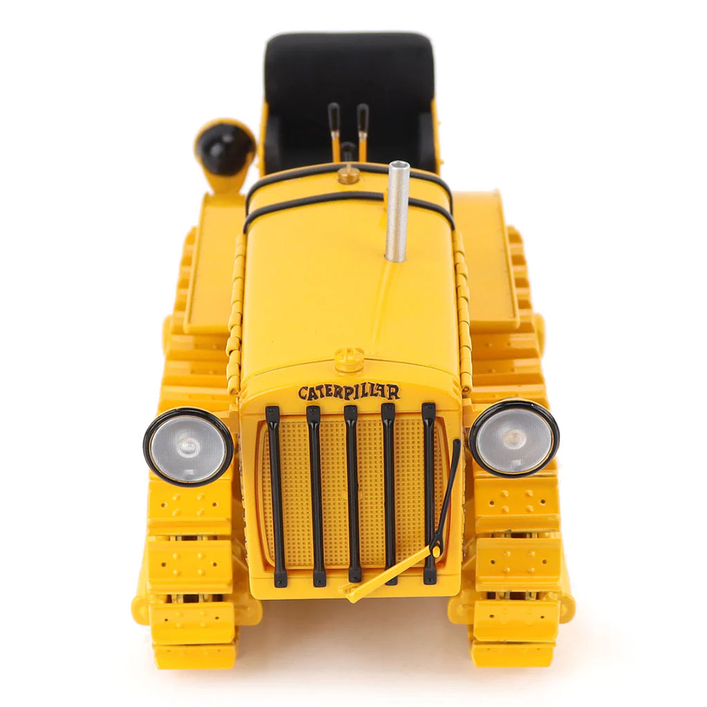 Model of a CAT Machine Yellow Caterpillar Twenty-Five Crawler Tractor with Headlights on a White Background