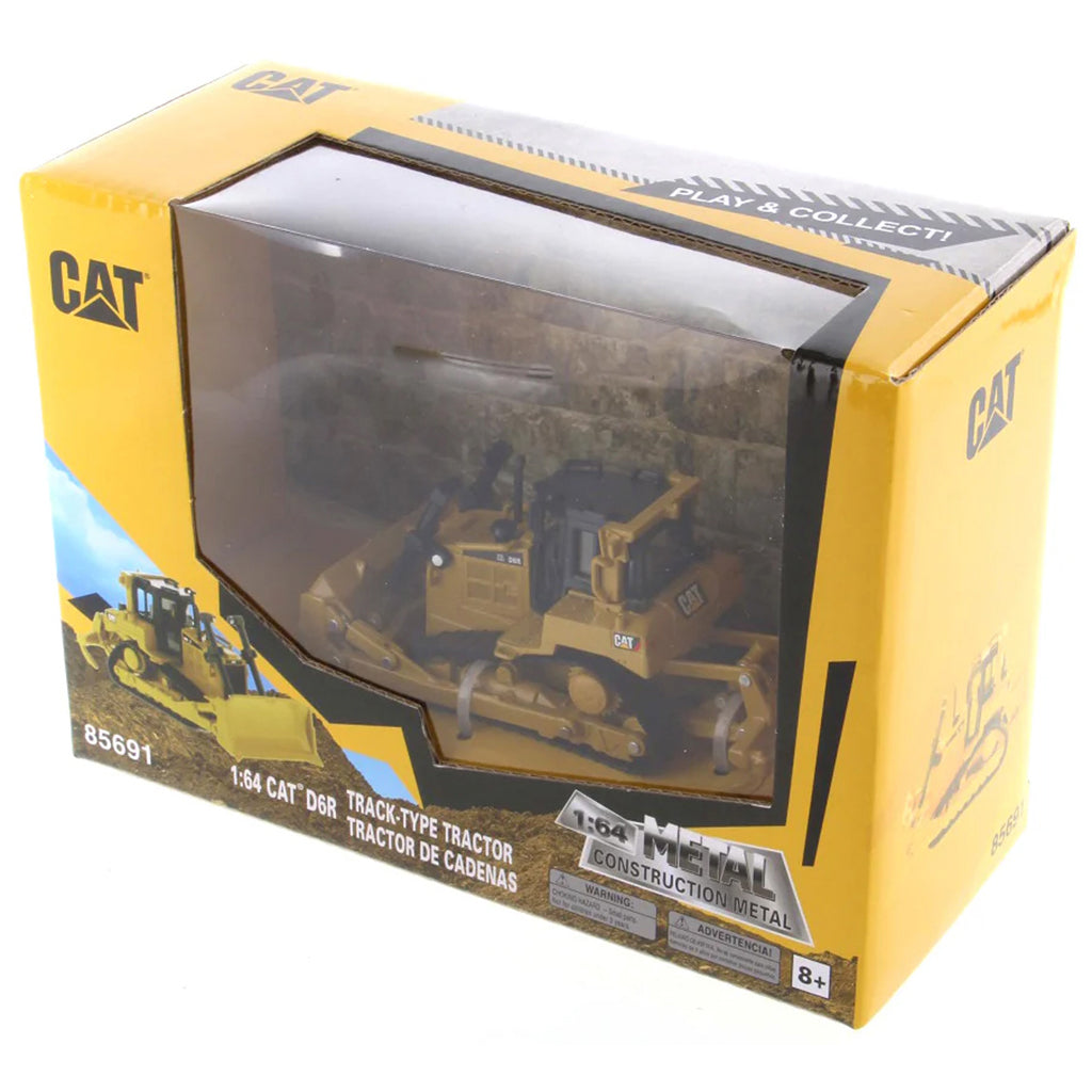 Model of a Caterpillar tractor in a yellow box packaging on a white background