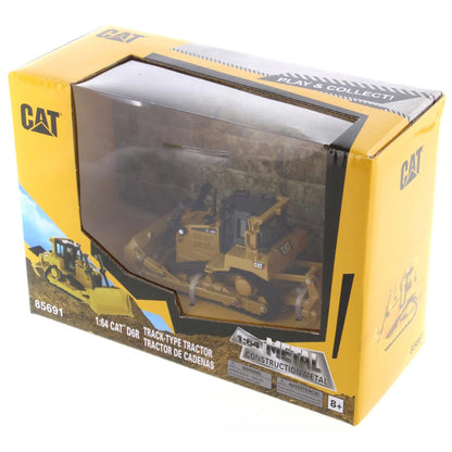 Model of a Caterpillar tractor in a yellow box packaging on a white background