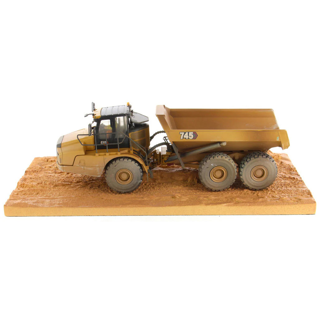 Model of Weathered Caterpillar 745 Articulated Dump Truck Mounted on a Simulated Dirt Road Base on a White Background