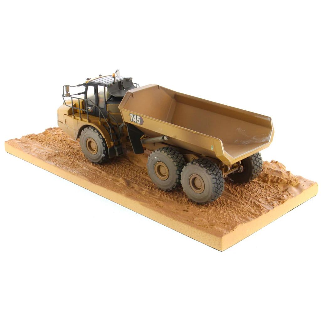 Model of Weathered Caterpillar 745 Articulated Dump Truck Mounted on a Simulated Dirt Road Base on a White Background