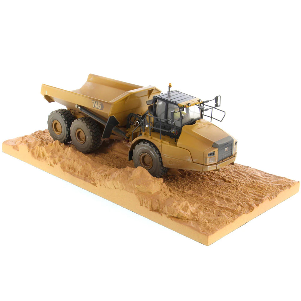 Model of Weathered Caterpillar 745 Articulated Dump Truck Mounted on a Simulated Dirt Road Base on a White Background