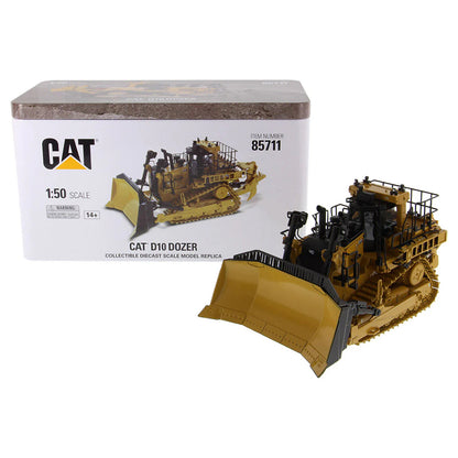 Model of a Caterpillar D10 dozer in front of its packaging box.