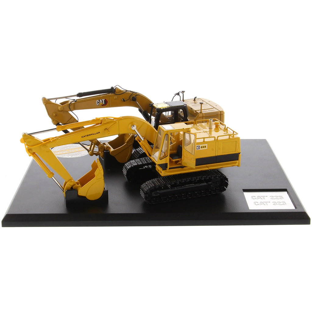 Two Caterpillar Excavator Models on a Black Base and White Background