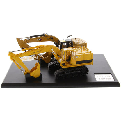 Two Caterpillar Excavator Models on a Black Base and White Background