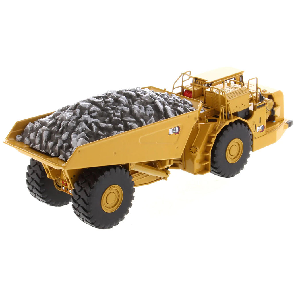 Model of a Caterpillar AD45 Underground Articulated Dump Truck with a Load of Coal on a White Background