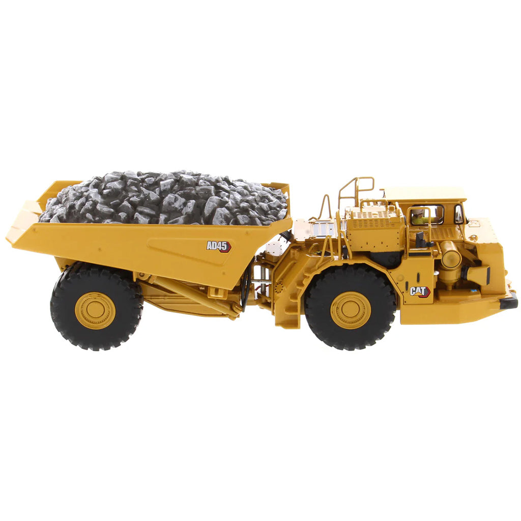 Model of a Caterpillar AD45 Underground Articulated Dump Truck with a Load of Coal on a White Background
