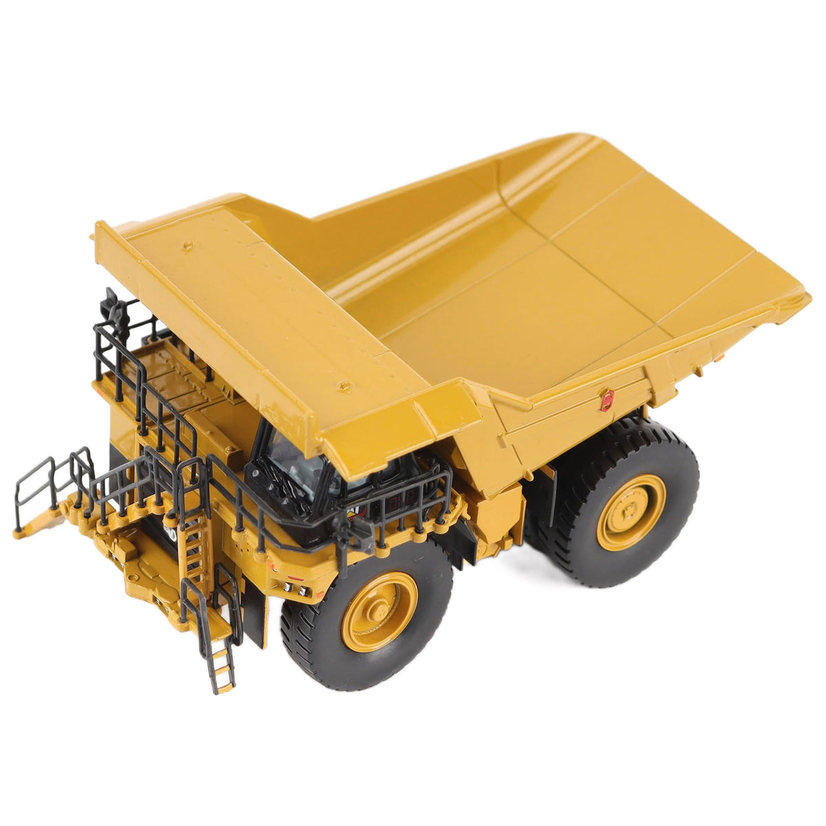 1/87th Scale Diecast Model of a CAT Yellow and Black Caterpillar 785 Mining Dump Truck Photographed on a White Background