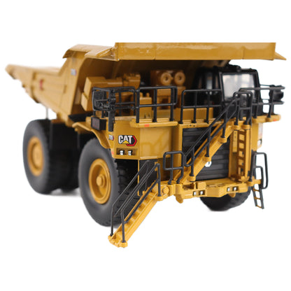 1/87th Scale Diecast Model of a CAT Yellow and Black Caterpillar 785 Mining Dump Truck Photographed on a White Background