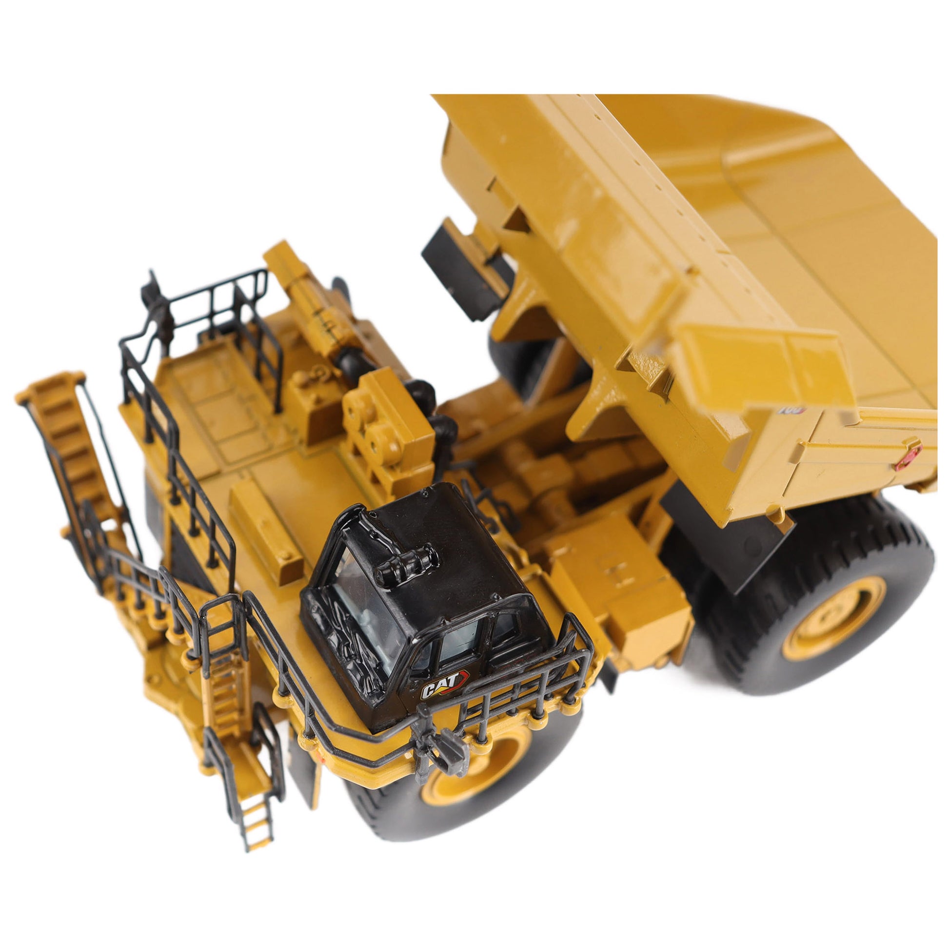 1/87th Scale Diecast Model of a CAT Yellow and Black Caterpillar 785 Mining Dump Truck Photographed on a White Background