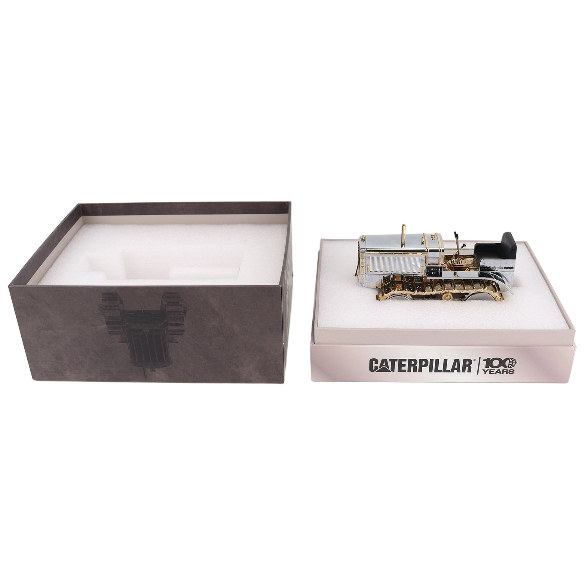 1:16th Scale Diecast Model of a Caterpillar Twenty Crawler Tractor that is Chrome Plated with Gold Plated Accents in Packaging Photographed on a White Background
