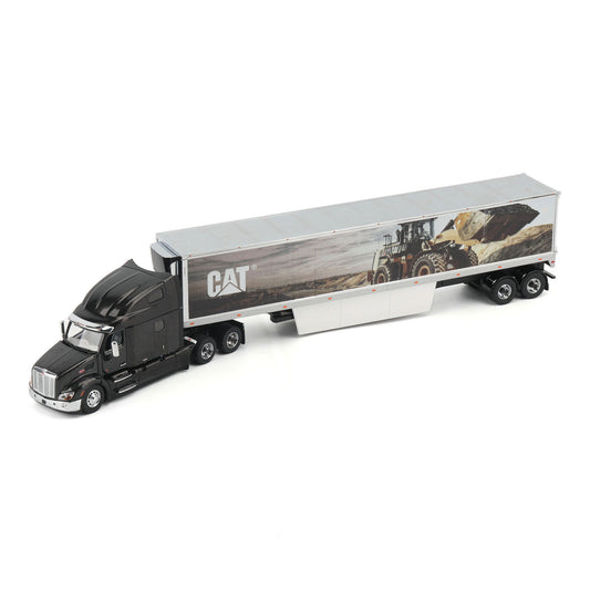 A die-cast model of a semi-truck with a black cab and a silver trailer featuring a CAT logo and a construction scene graphic, shown on a white background.
