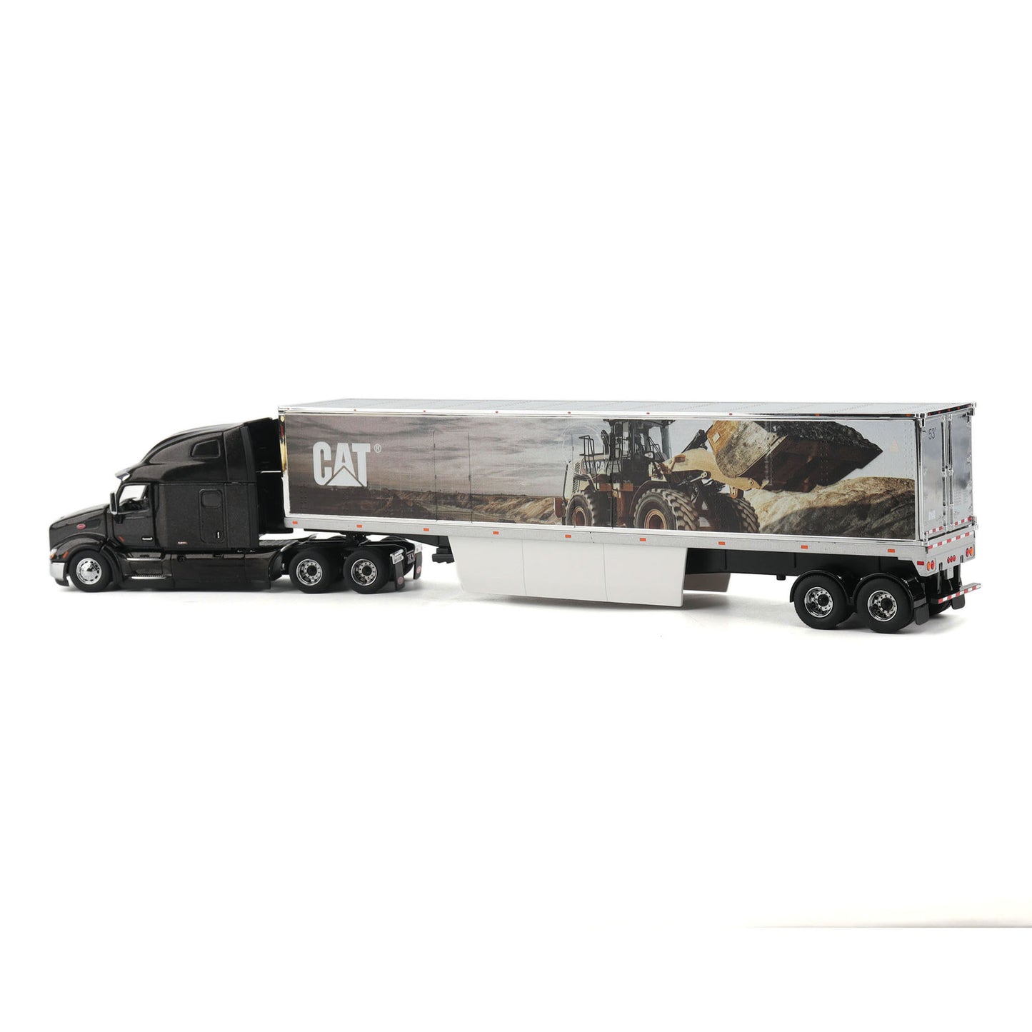 A die-cast model of a semi-truck with a black cab and a white trailer featuring a CAT construction graphic, shown on a plain white background.