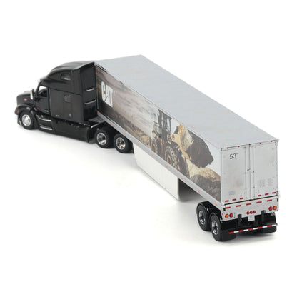 A diecast model of a semi-truck with a black cab and a white trailer printed with a CAT construction graphic, shown on a white background.