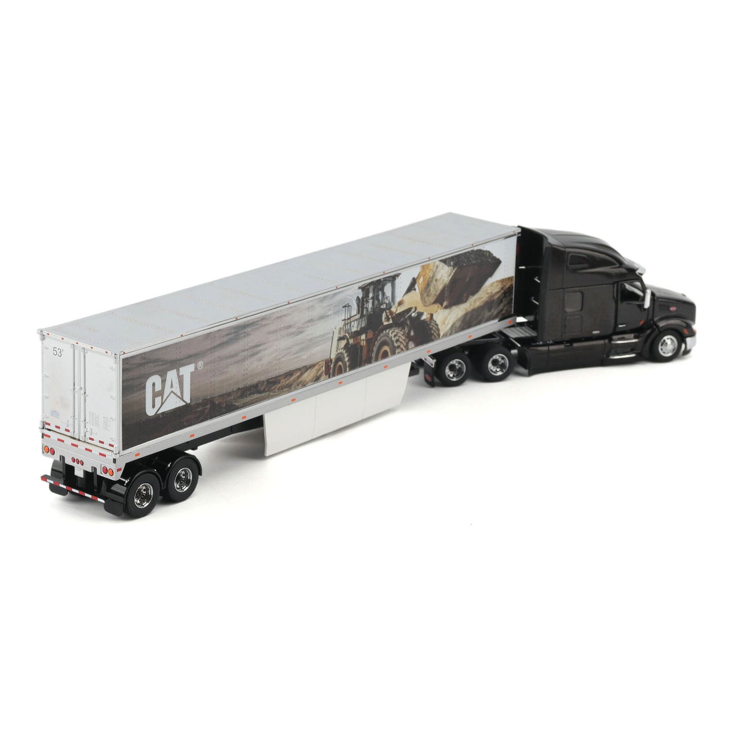 A die-cast model of a semi-truck with a black cab and a silver semi-trailer featuring a CAT logo and a construction scene graphic, shown on a white background.
