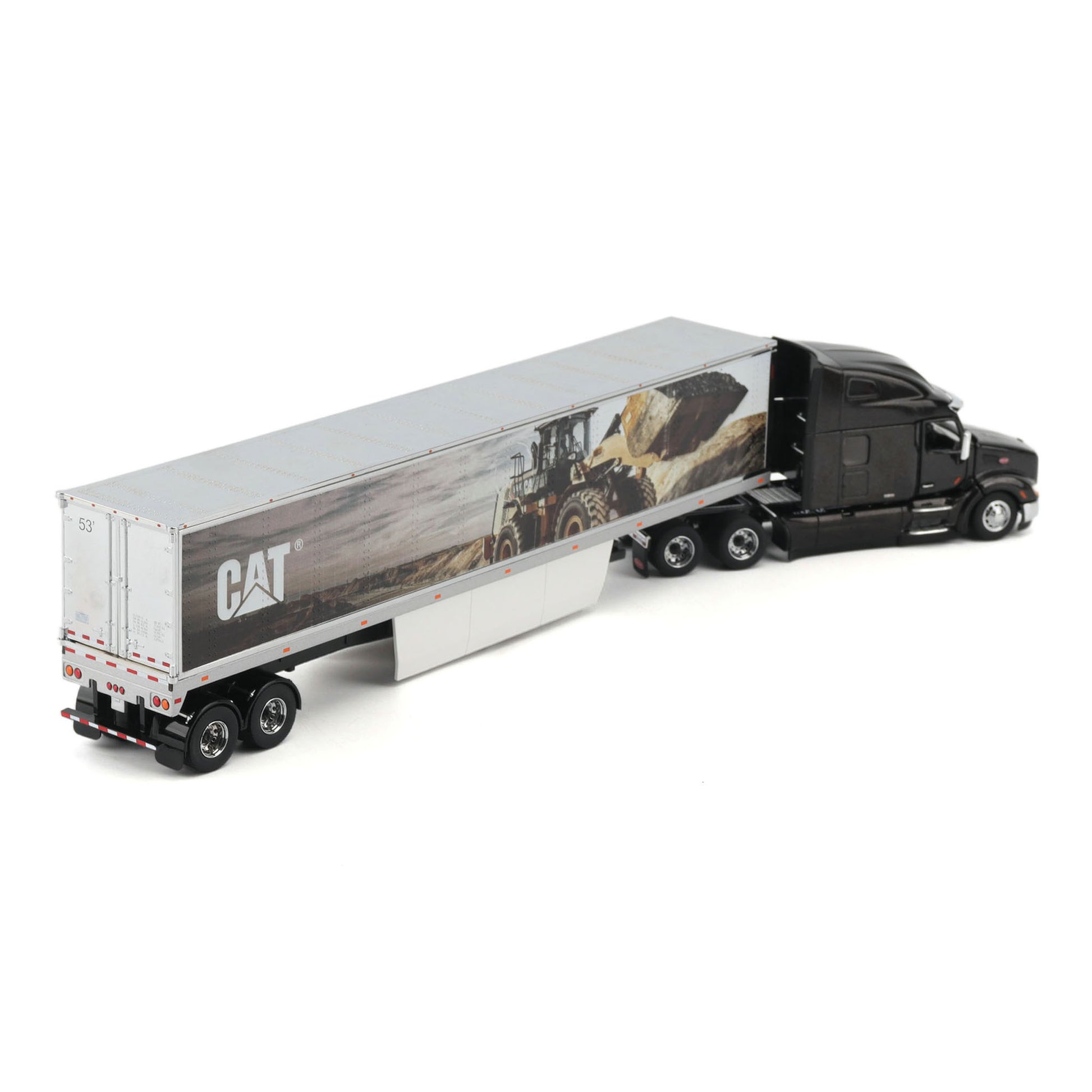 A die-cast model of a semi-truck with a black cab and a silver semi-trailer featuring a CAT logo and a construction scene graphic, shown on a white background.