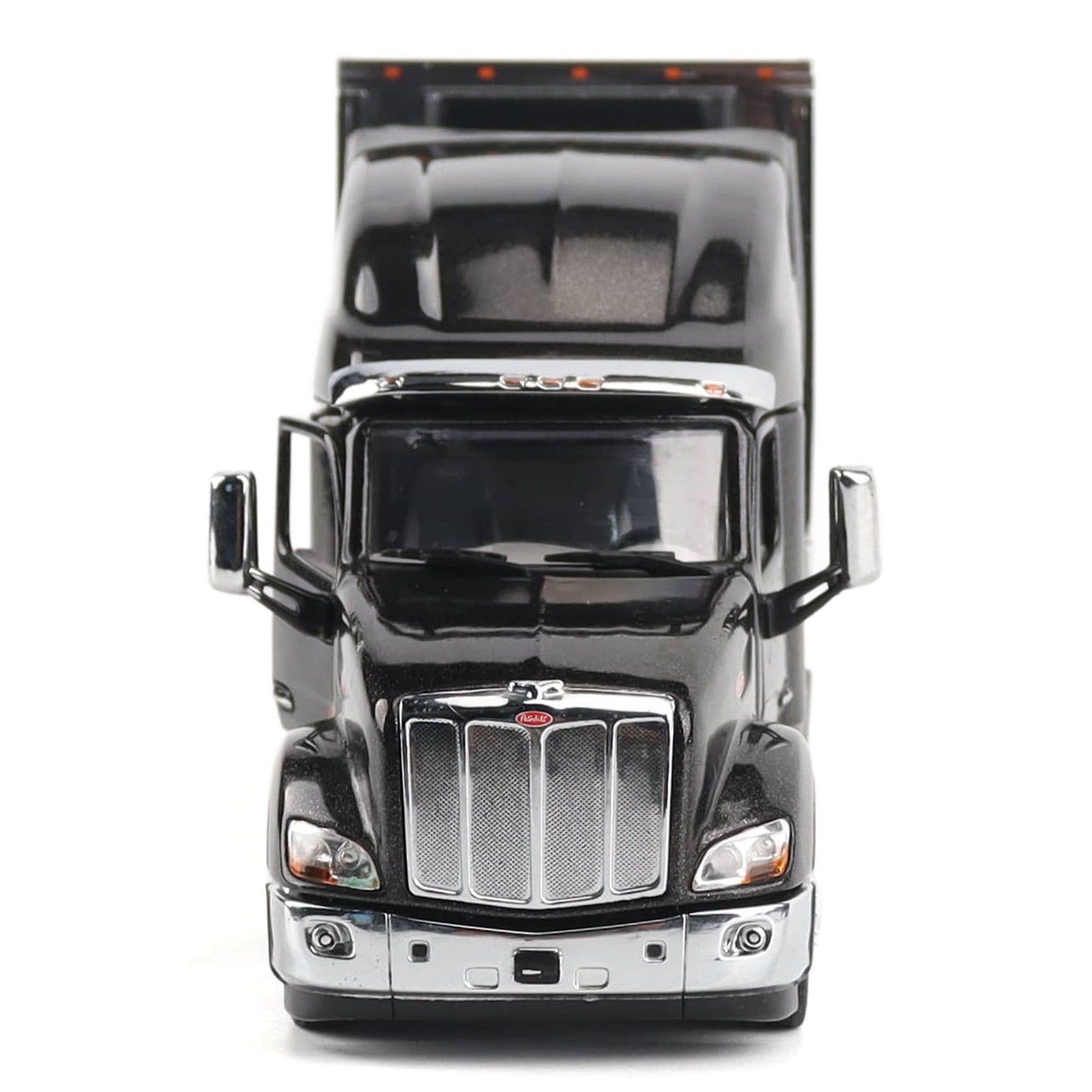 A black die-cast metal model semi-truck cab with chrome grille and mirrors, photographed from the front against a plain white background.