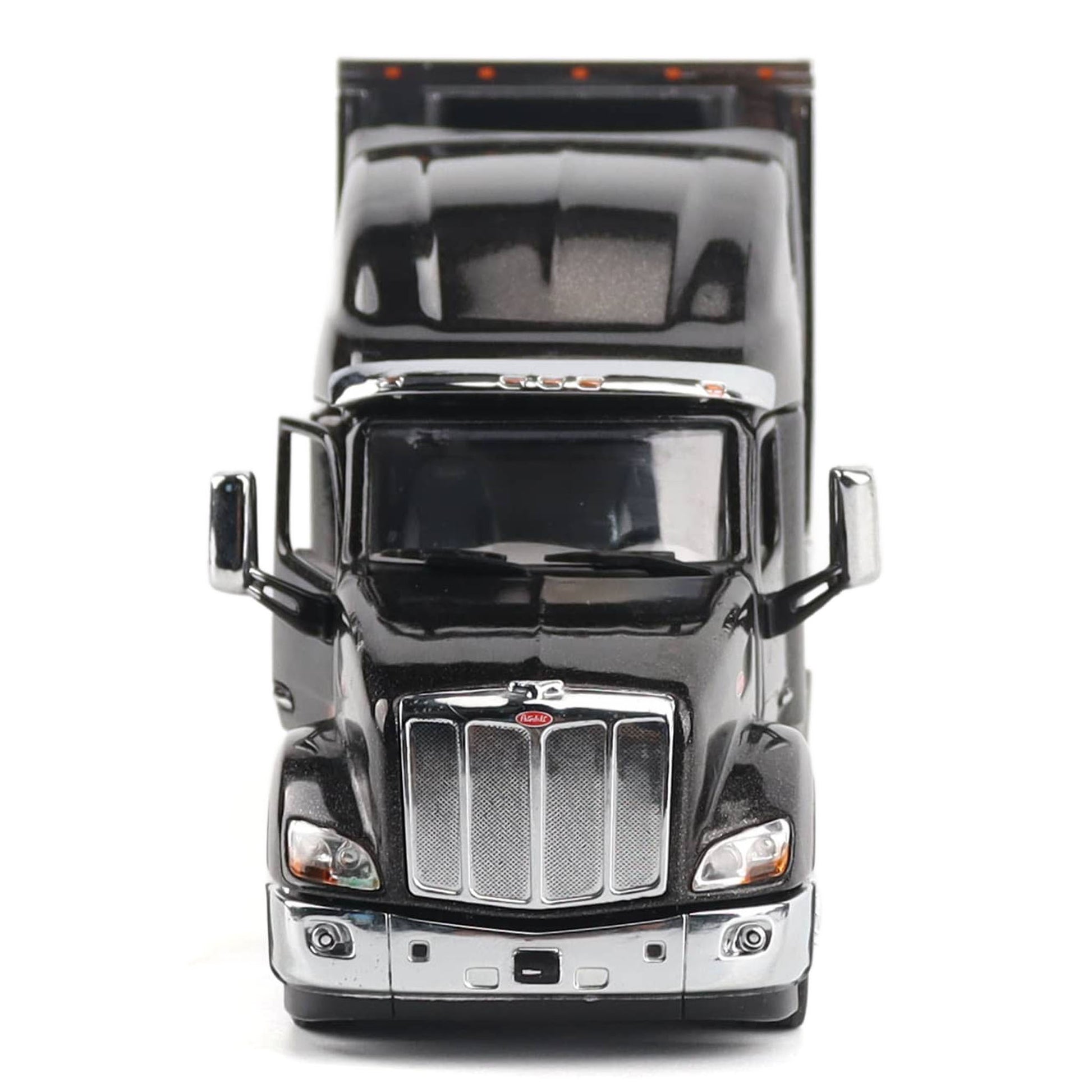 A black die-cast metal model semi-truck cab with chrome grille and mirrors, photographed from the front against a plain white background.