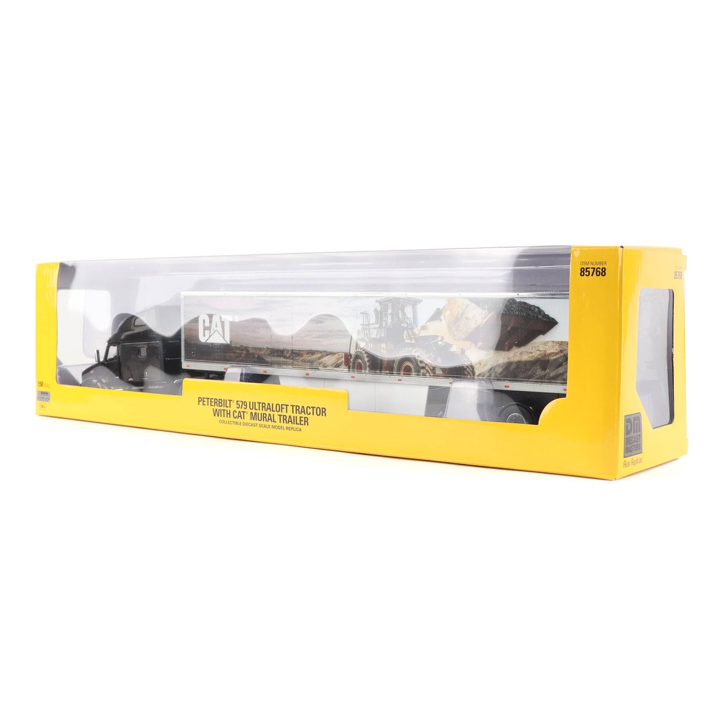 A yellow and clear plastic retail box containing a model toy of a Cat tractor trailer shown on a white background.