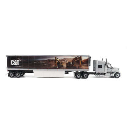 A die-cast model of a silver semi-truck with a long white box trailer featuring a large CAT construction graphic, shown on a white background.
