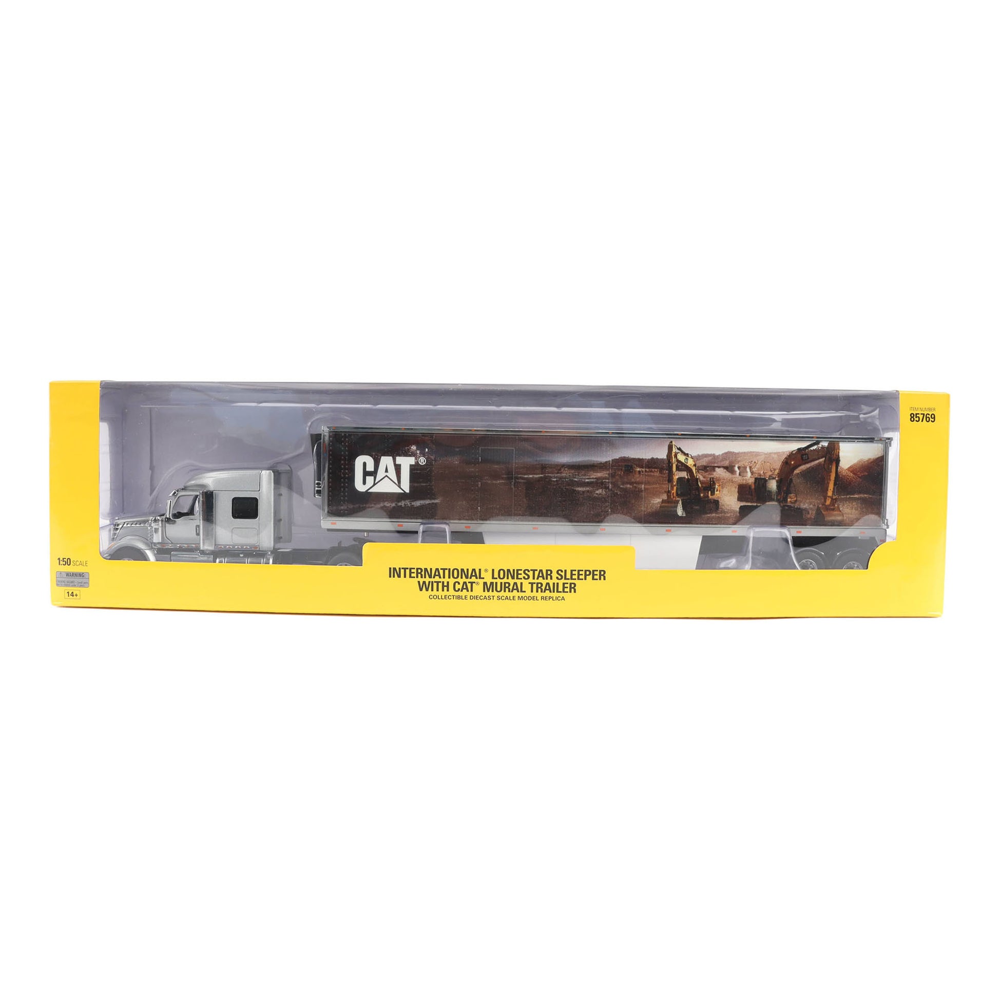 A toy model of an International Lonestar sleeper trailer with a CAT animal trailer, shown inside its yellow retail packaging on a white background.