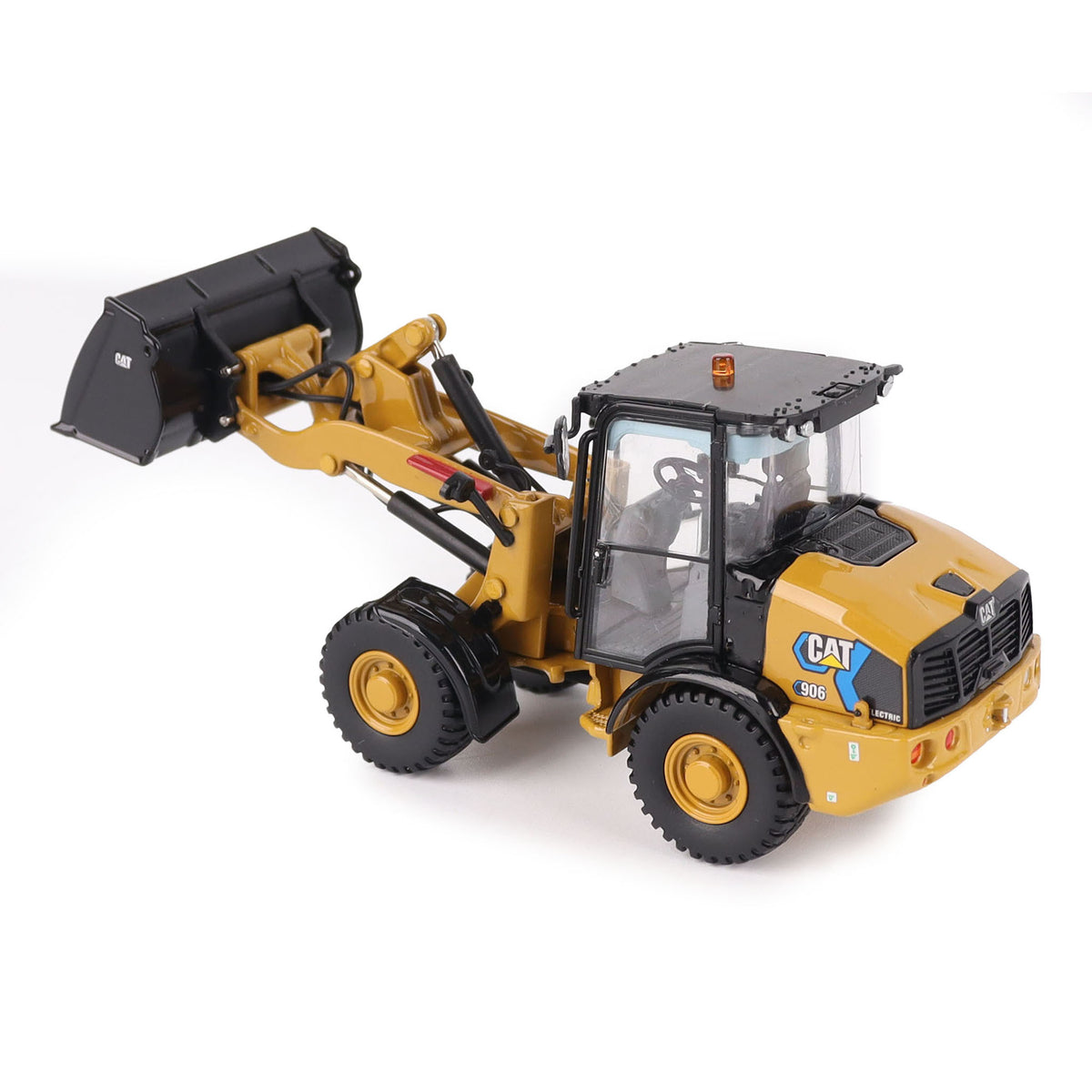 1:50th scale model of a Caterpillar 906M Electric Compact Wheel Loader photographed on a white background