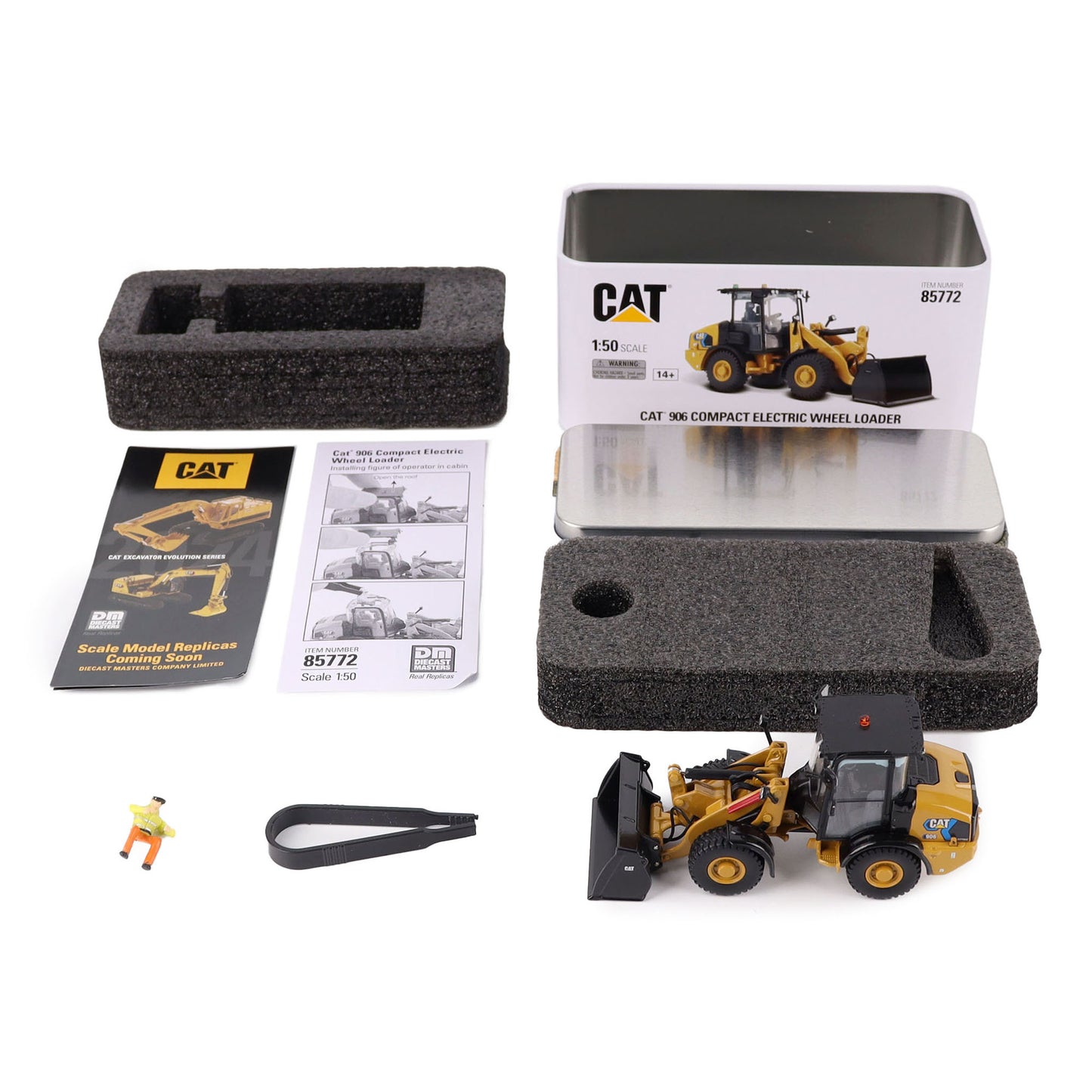 Cat model wheel loader with packaging, foam block, and accessories on a white background