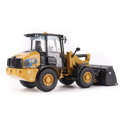 1:50th scale model of a Caterpillar 906M Electric Compact Wheel Loader photographed on a white background