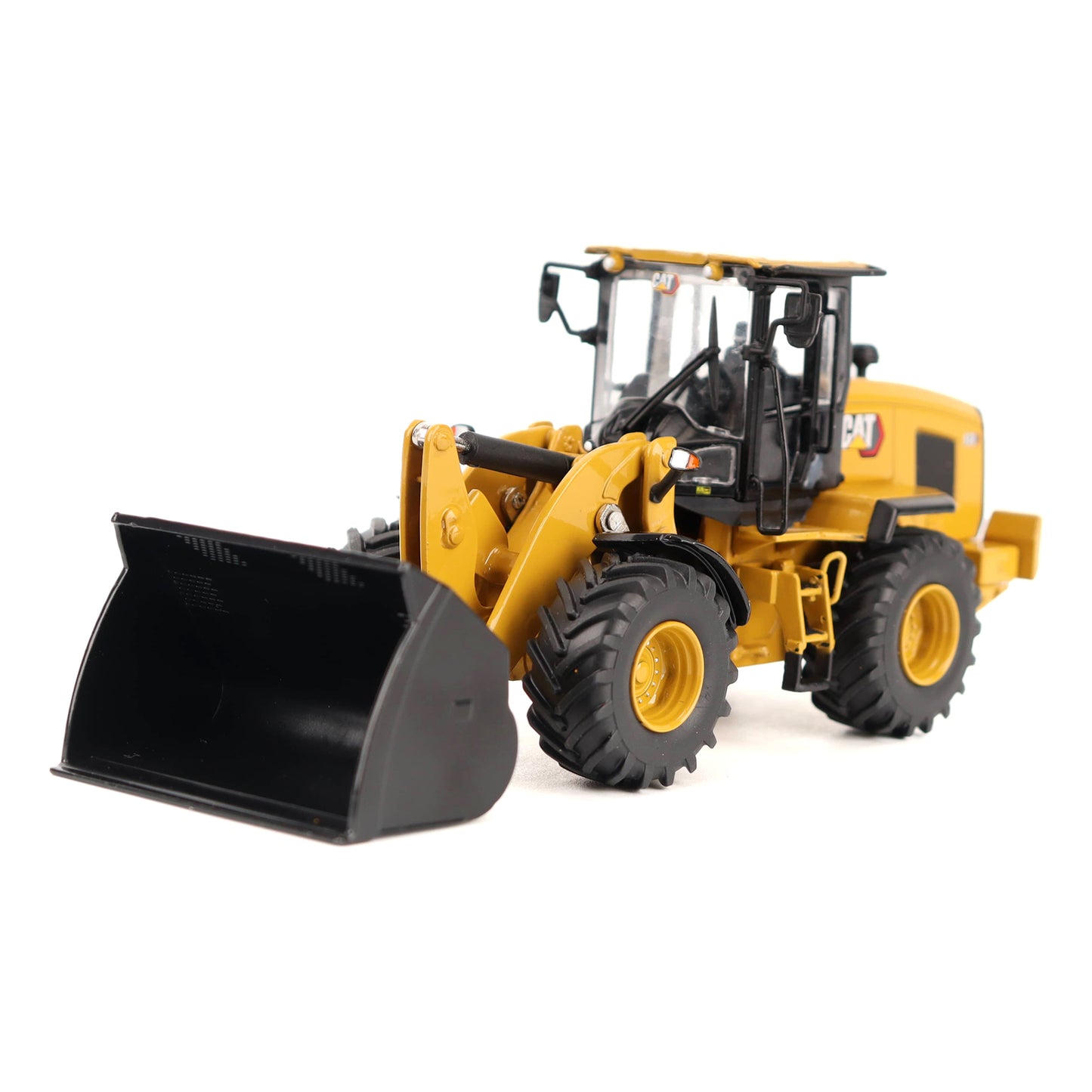 A yellow and black toy model of a wheel loader construction vehicle, shown from a three-quarters angle on a solid white background.